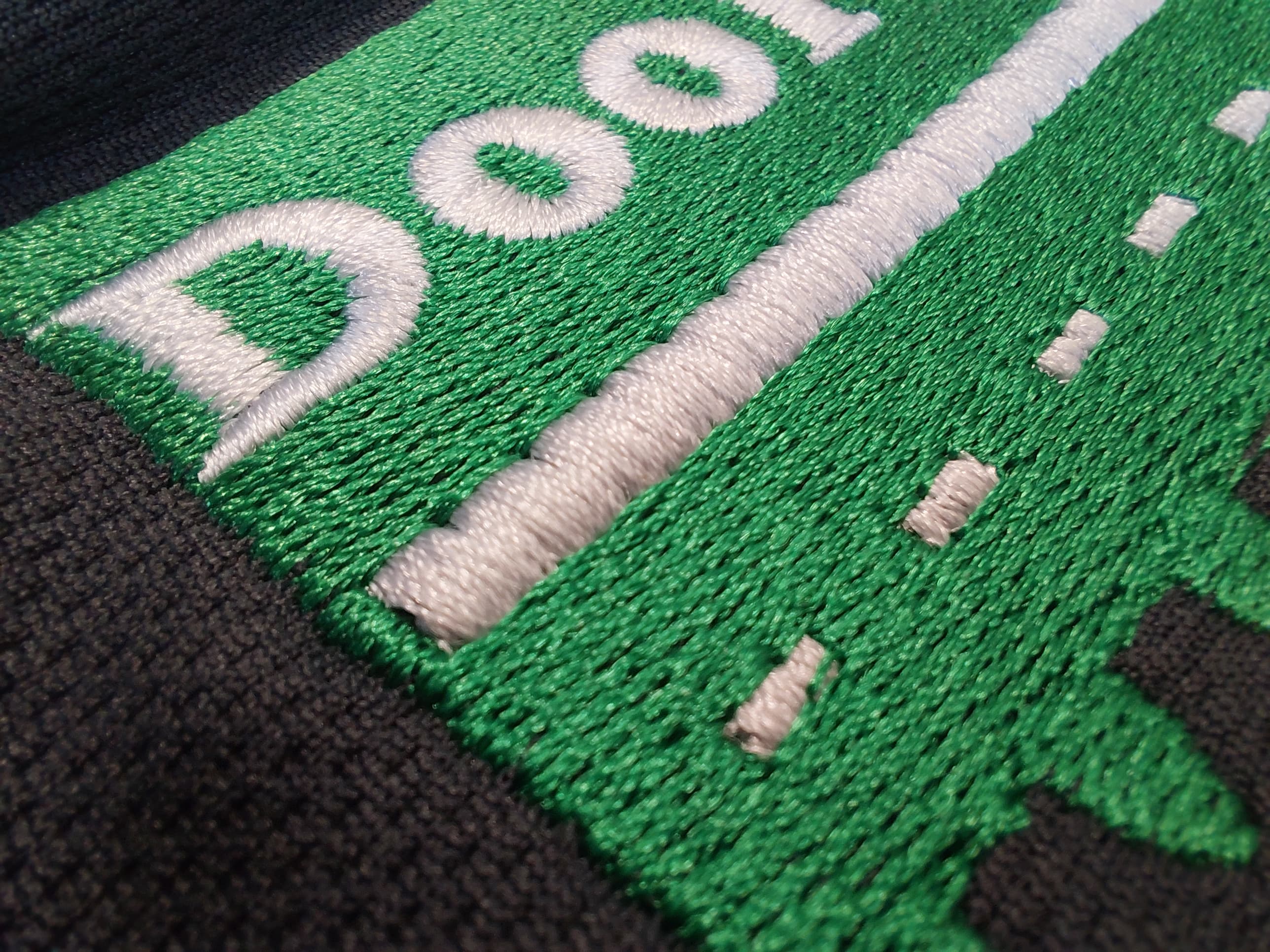 Close-up of detailed embroidery stitching on workwear